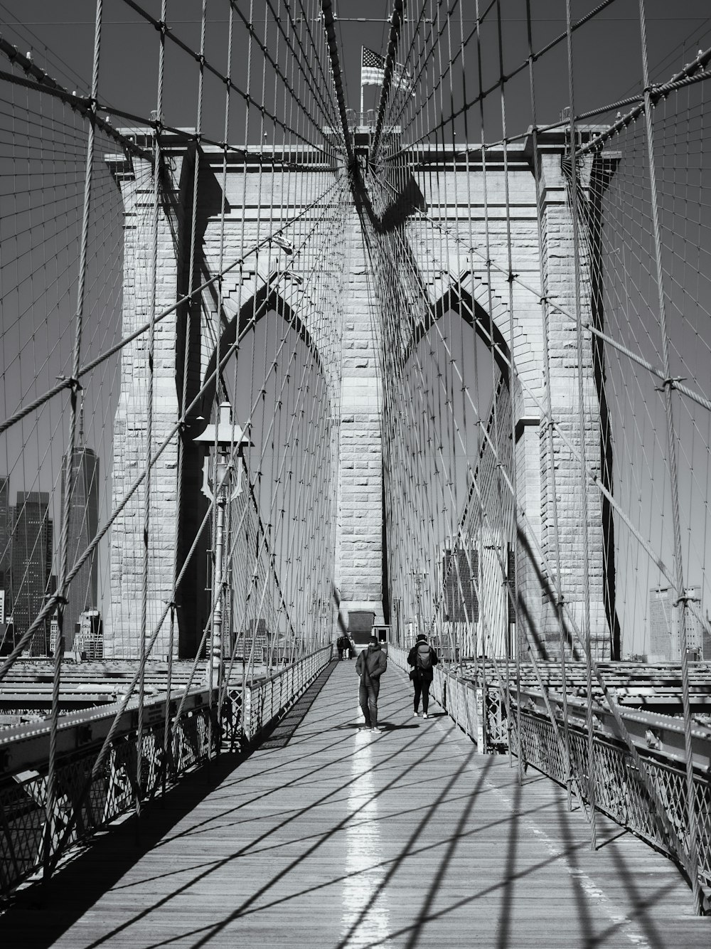 a couple of people walking across a bridge