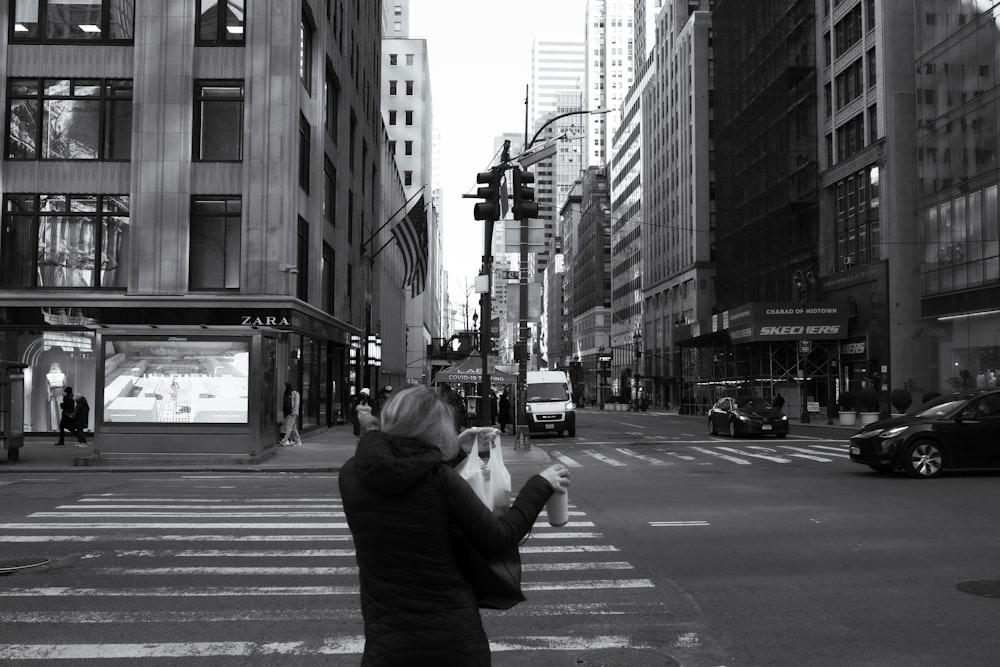 a woman is taking a picture of herself on the street