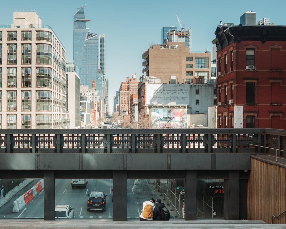 a couple of people that are standing on a bridge