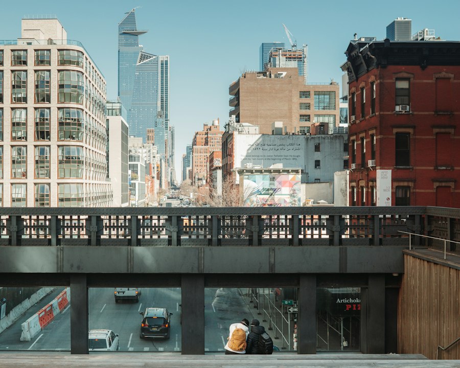 Two people standing on a bridge