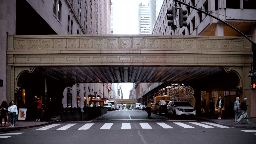 a city street with a bridge over it