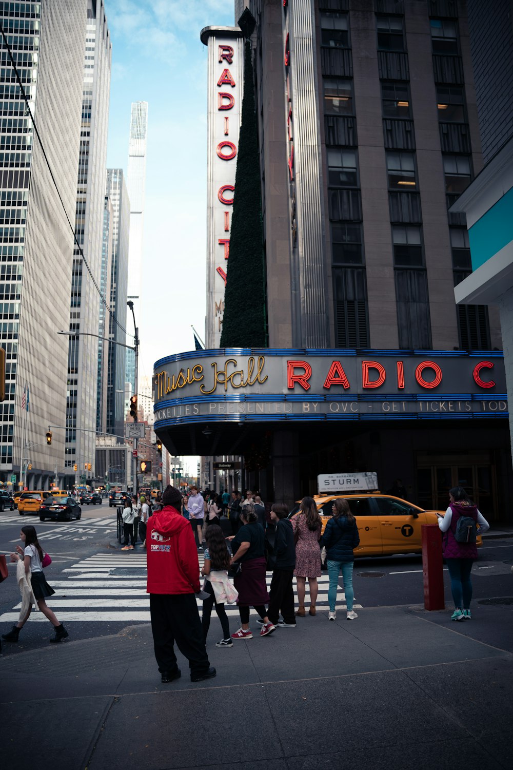 a group of people standing outside of a theater