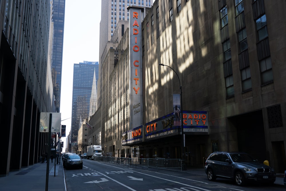 a city street with a theater sign on the side of it