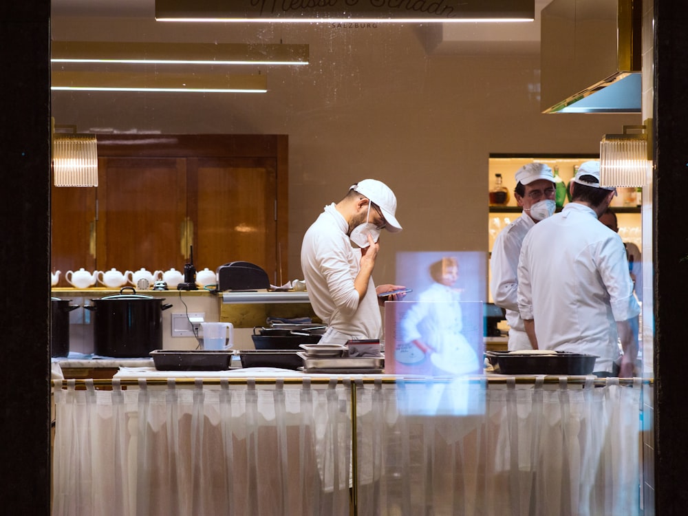 a group of chefs in a kitchen preparing food
