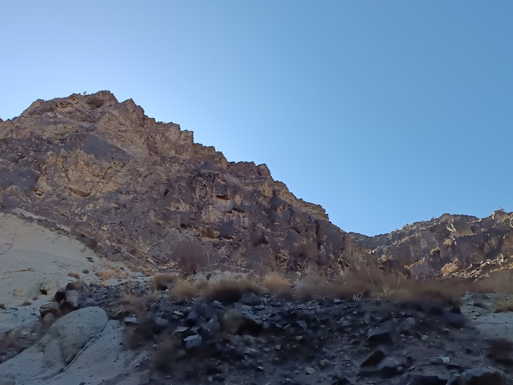 a view of a rocky mountain with a clear blue sky