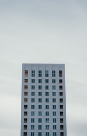 a very tall white building with lots of windows