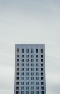 a very tall white building with lots of windows