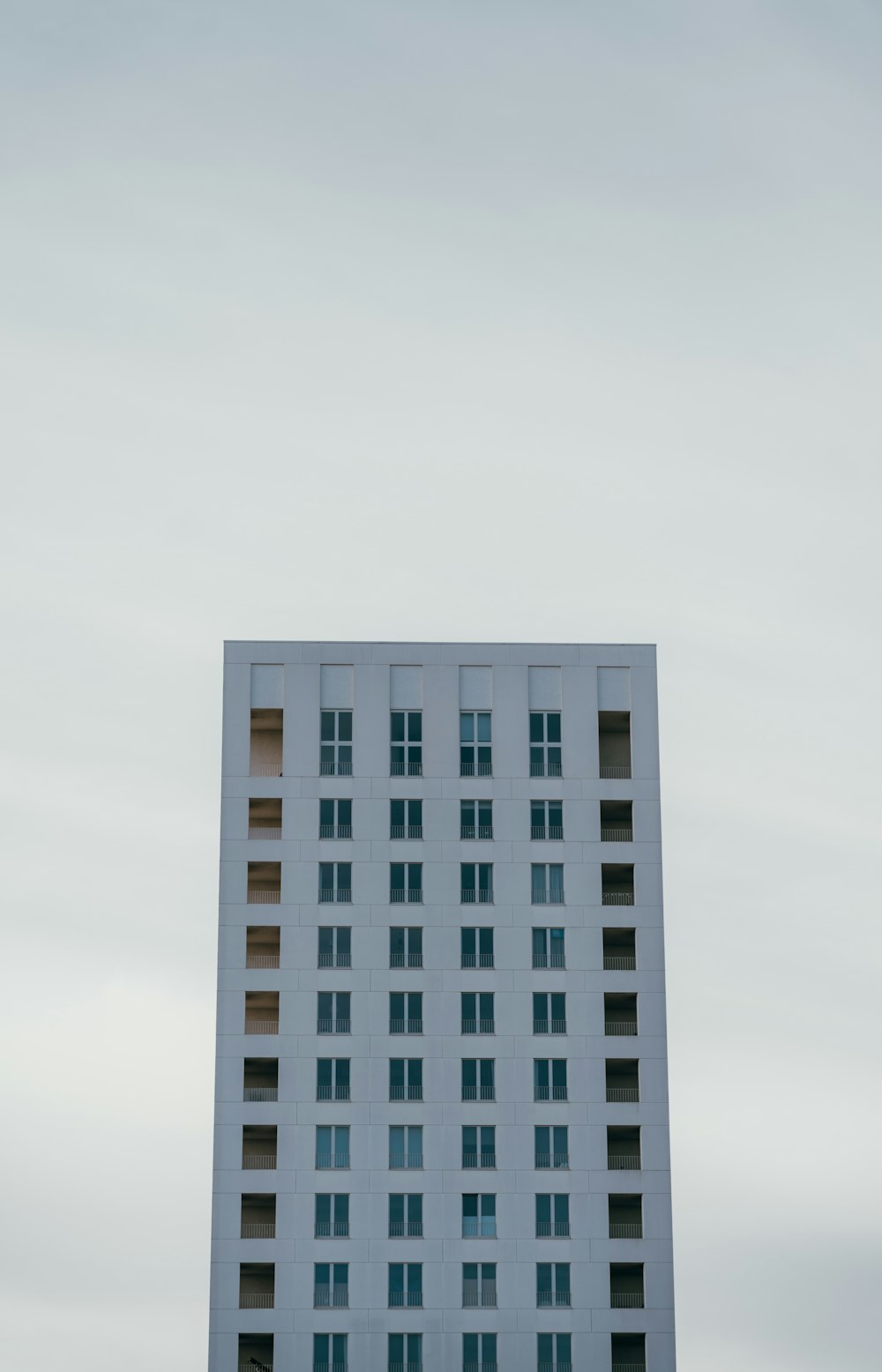 a very tall white building with lots of windows