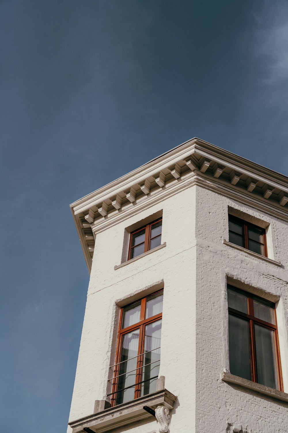 a tall white building with a clock on it's side