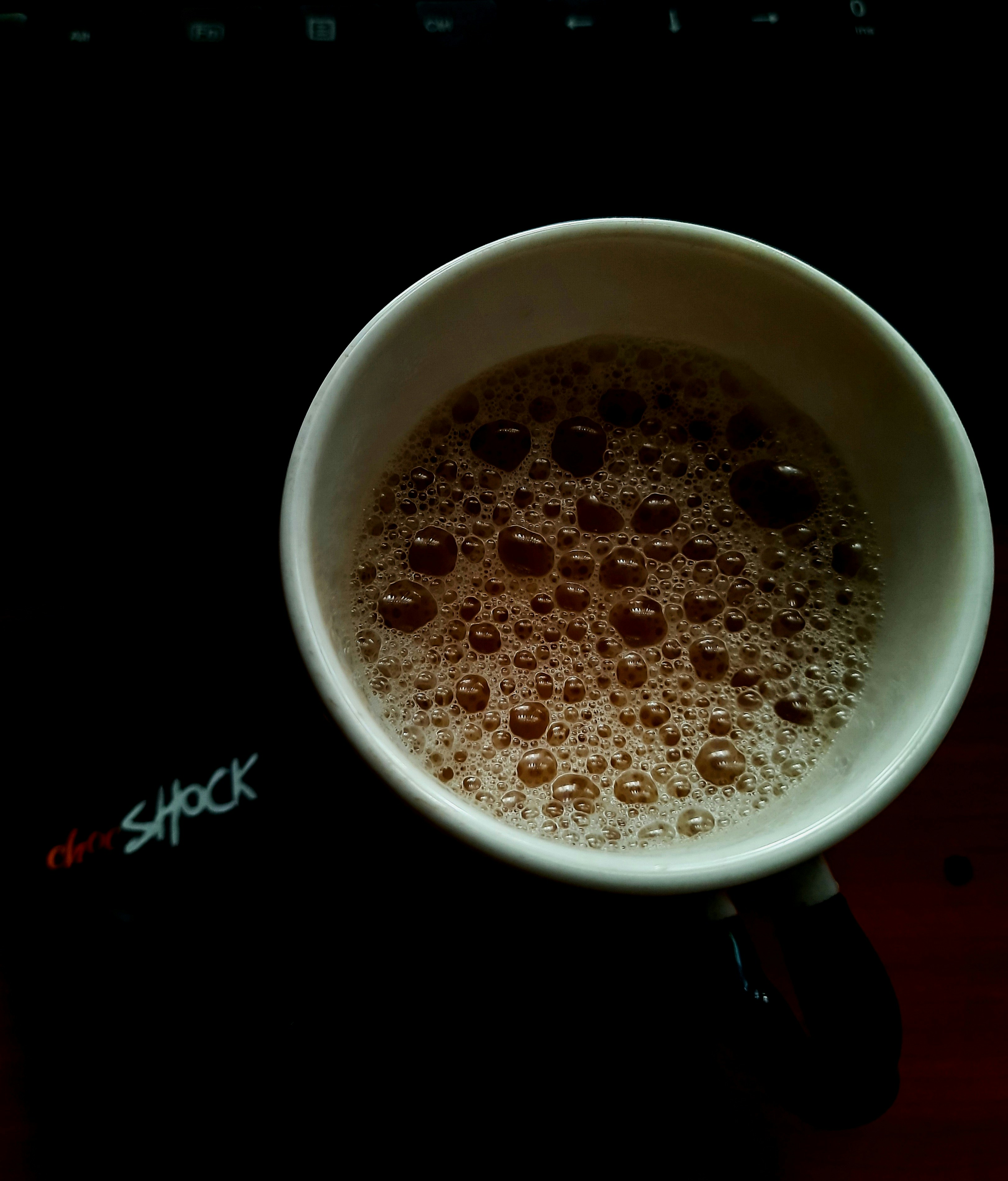 a cup of coffee sitting on top of a desk