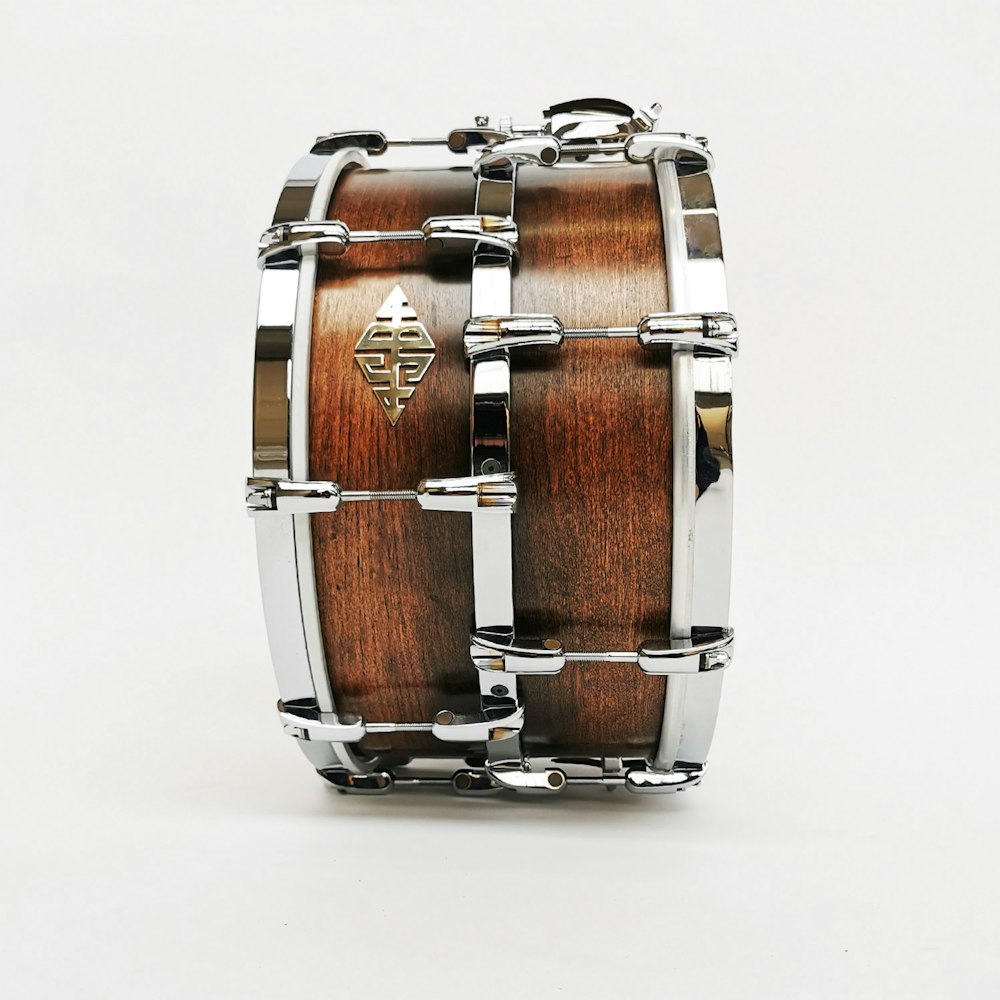 a close up of a wooden drum on a white background