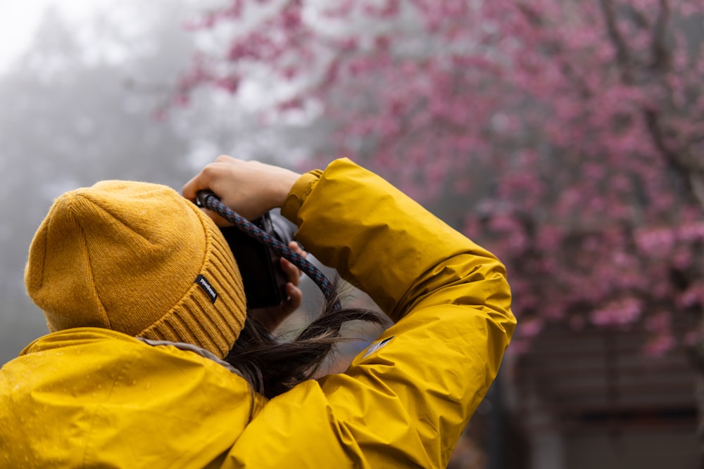 a person wearing a yellow jacket and a yellow hat