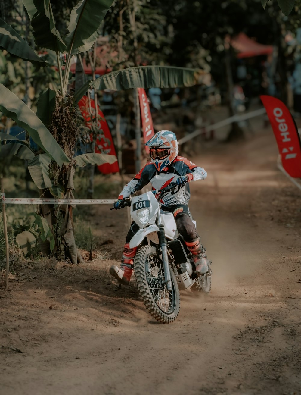 a person riding a dirt bike on a dirt road