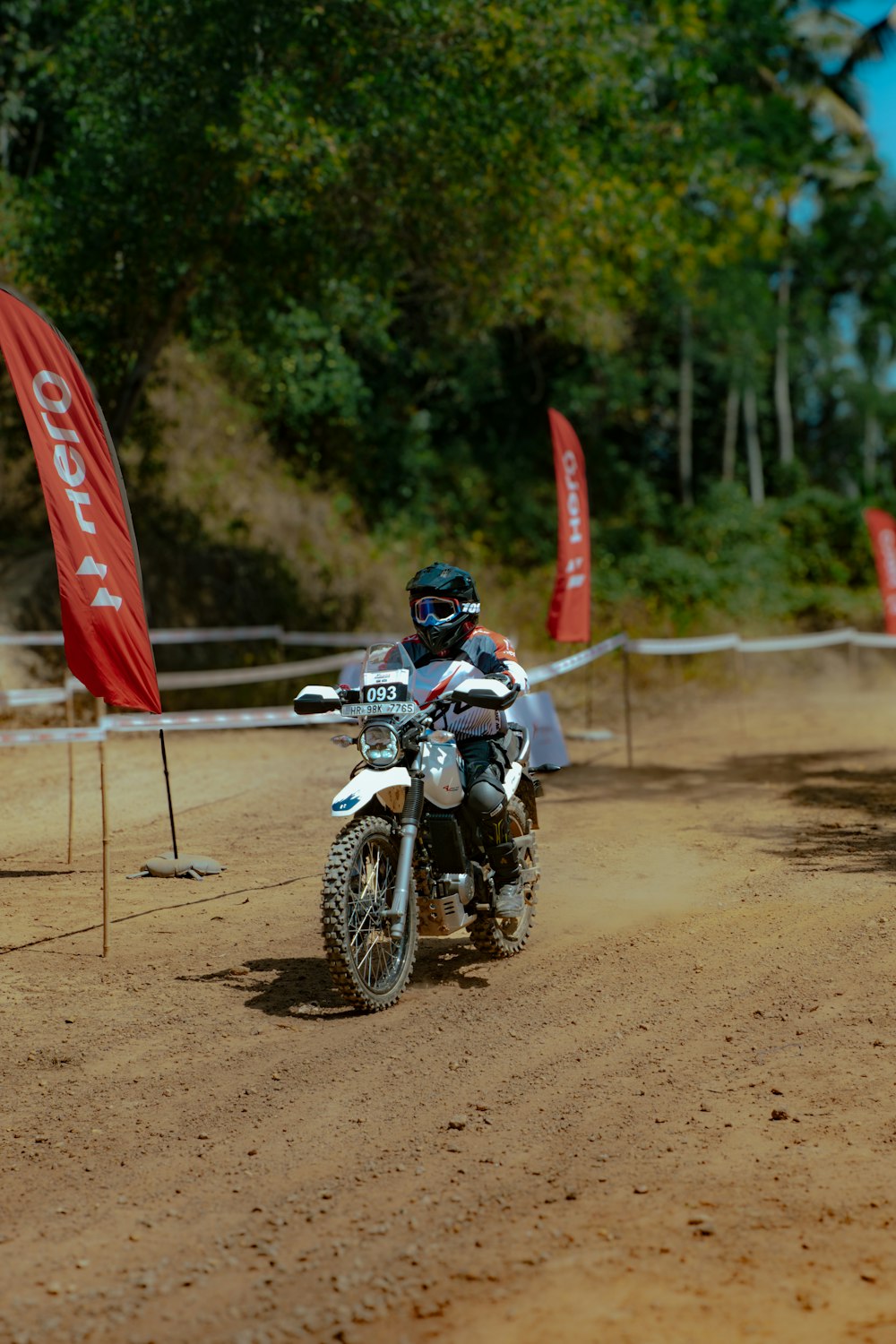 a person riding a dirt bike on a dirt track