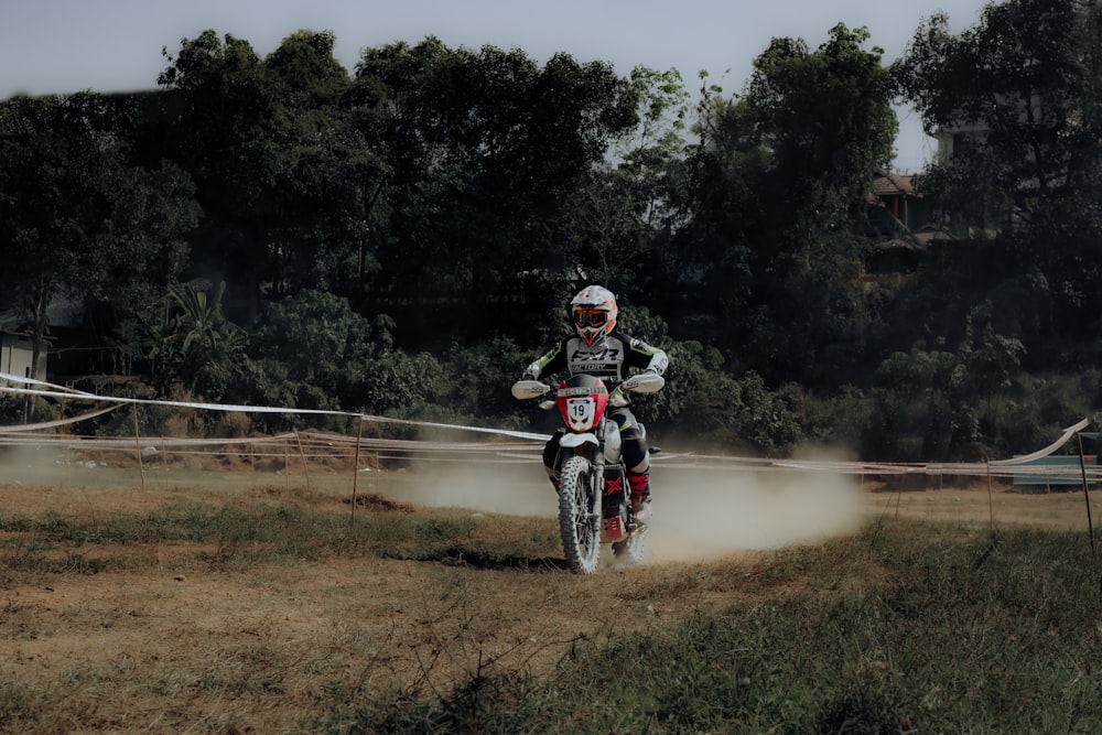 a person riding a dirt bike on a dirt track