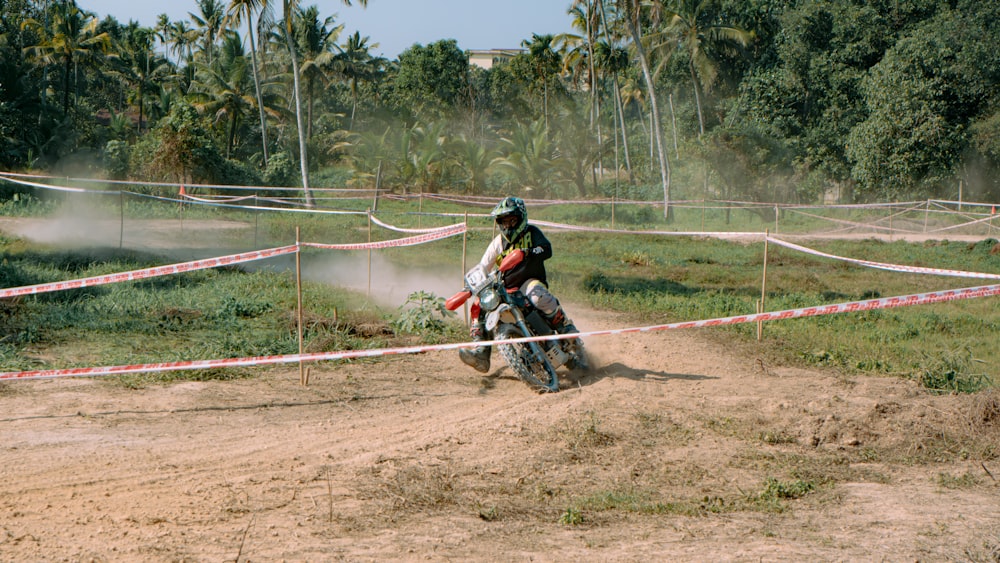 a man riding a dirt bike on top of a dirt road