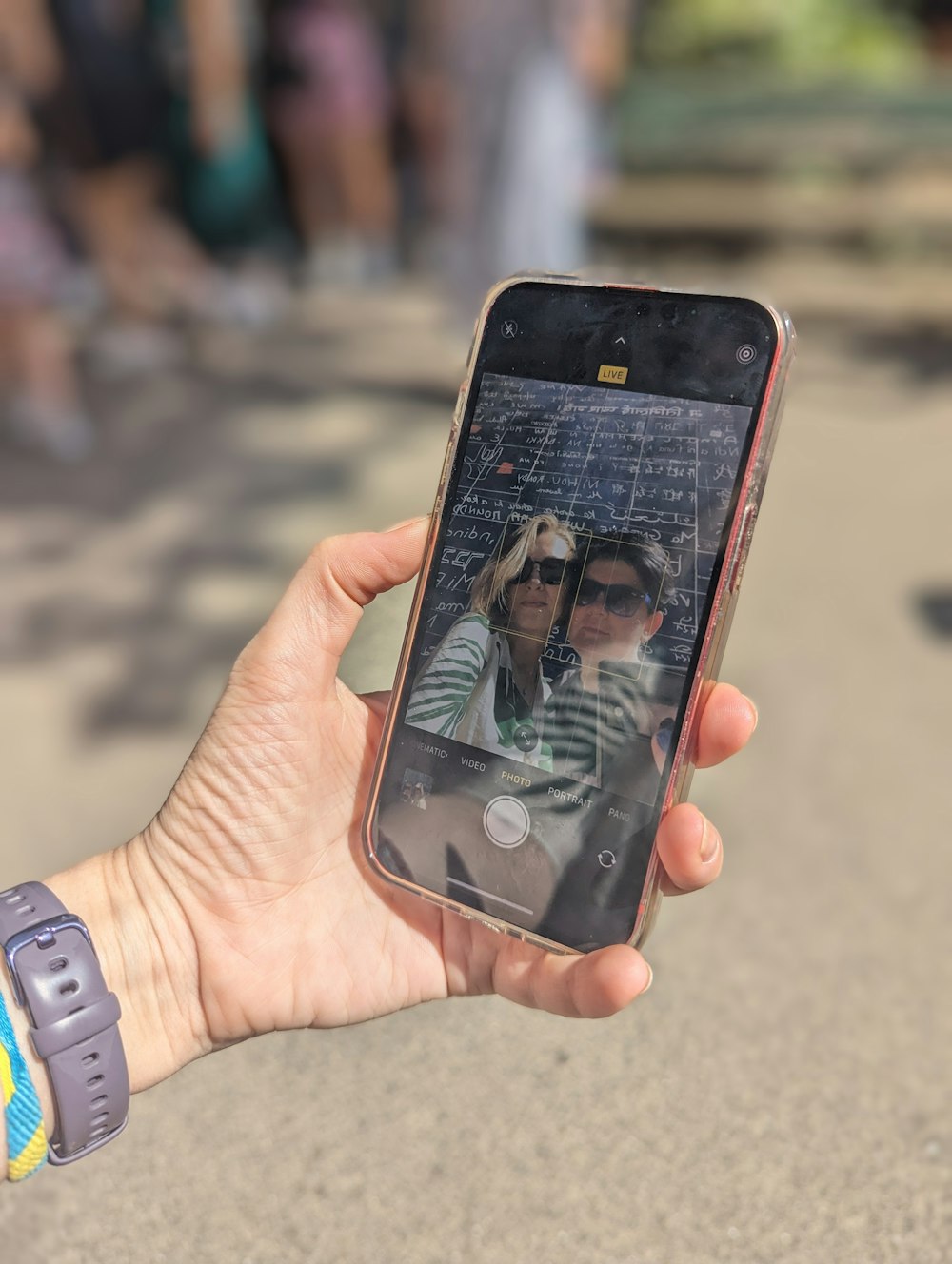 a person holding a cell phone with a picture of a woman