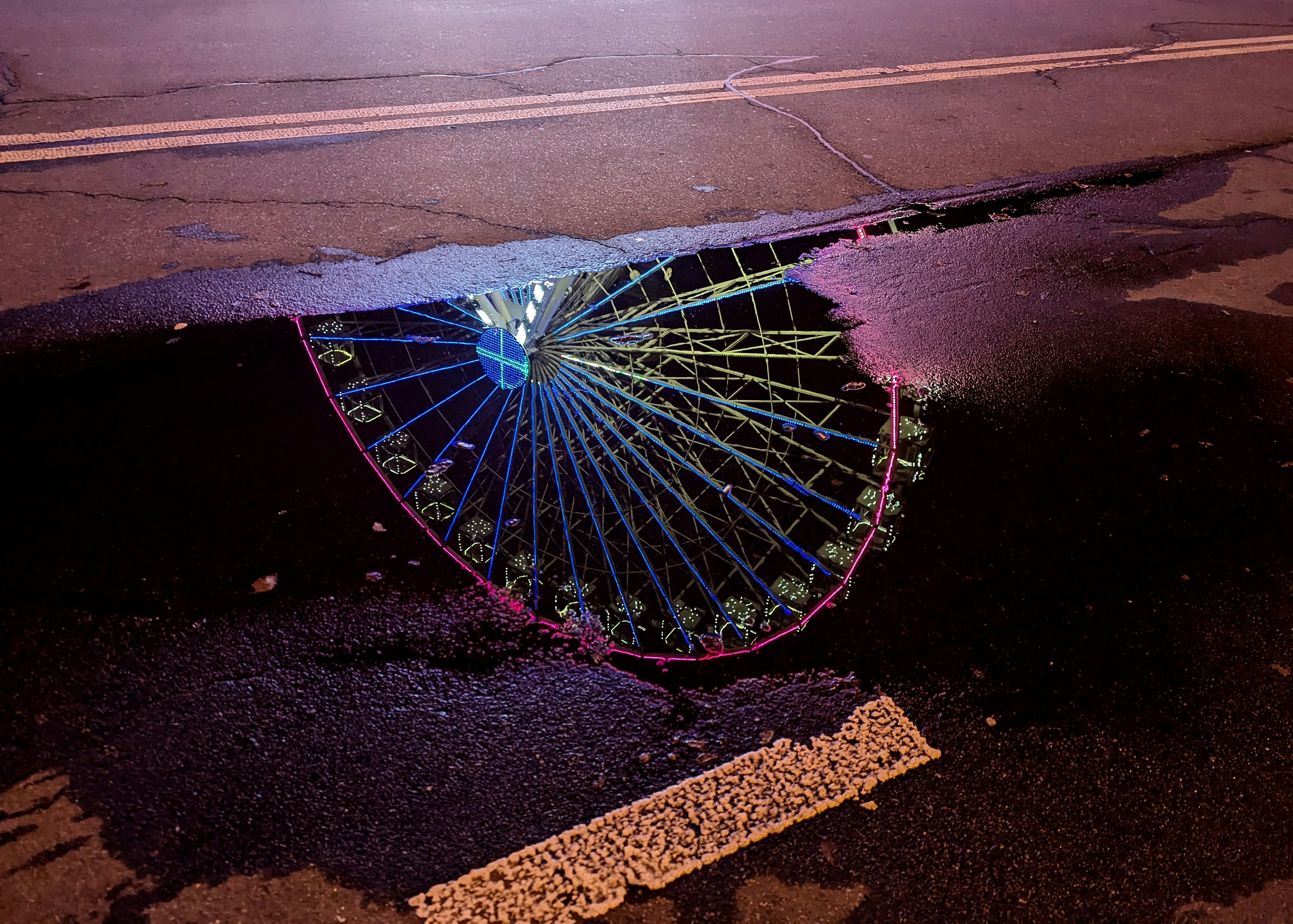 an upside down umbrella sitting on the side of a road