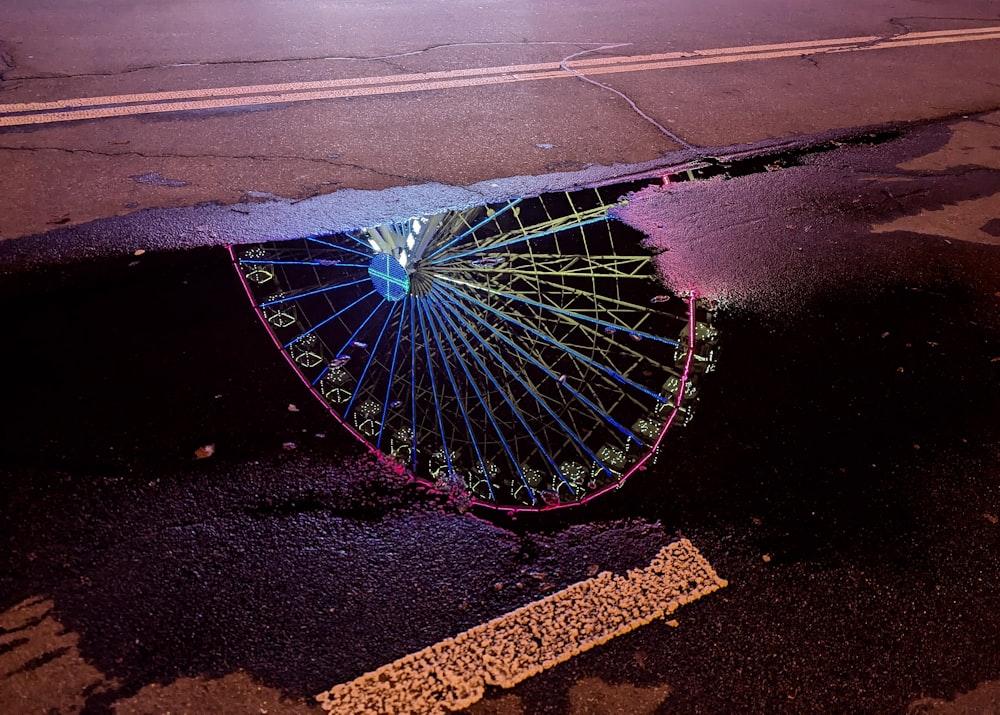an upside down umbrella sitting on the side of a road