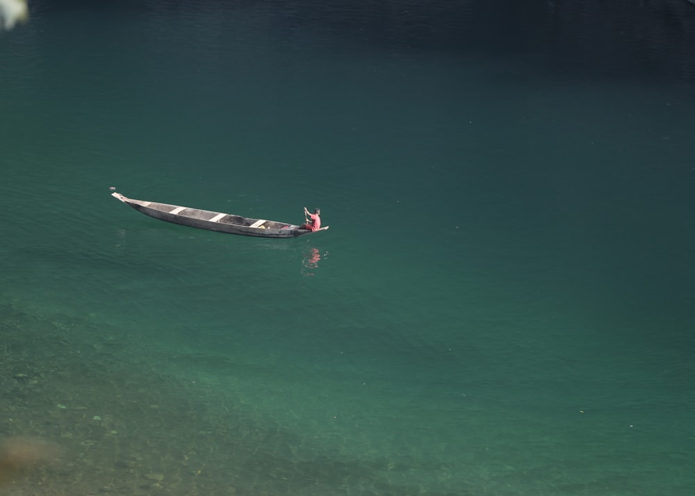 a small boat floating on top of a body of water