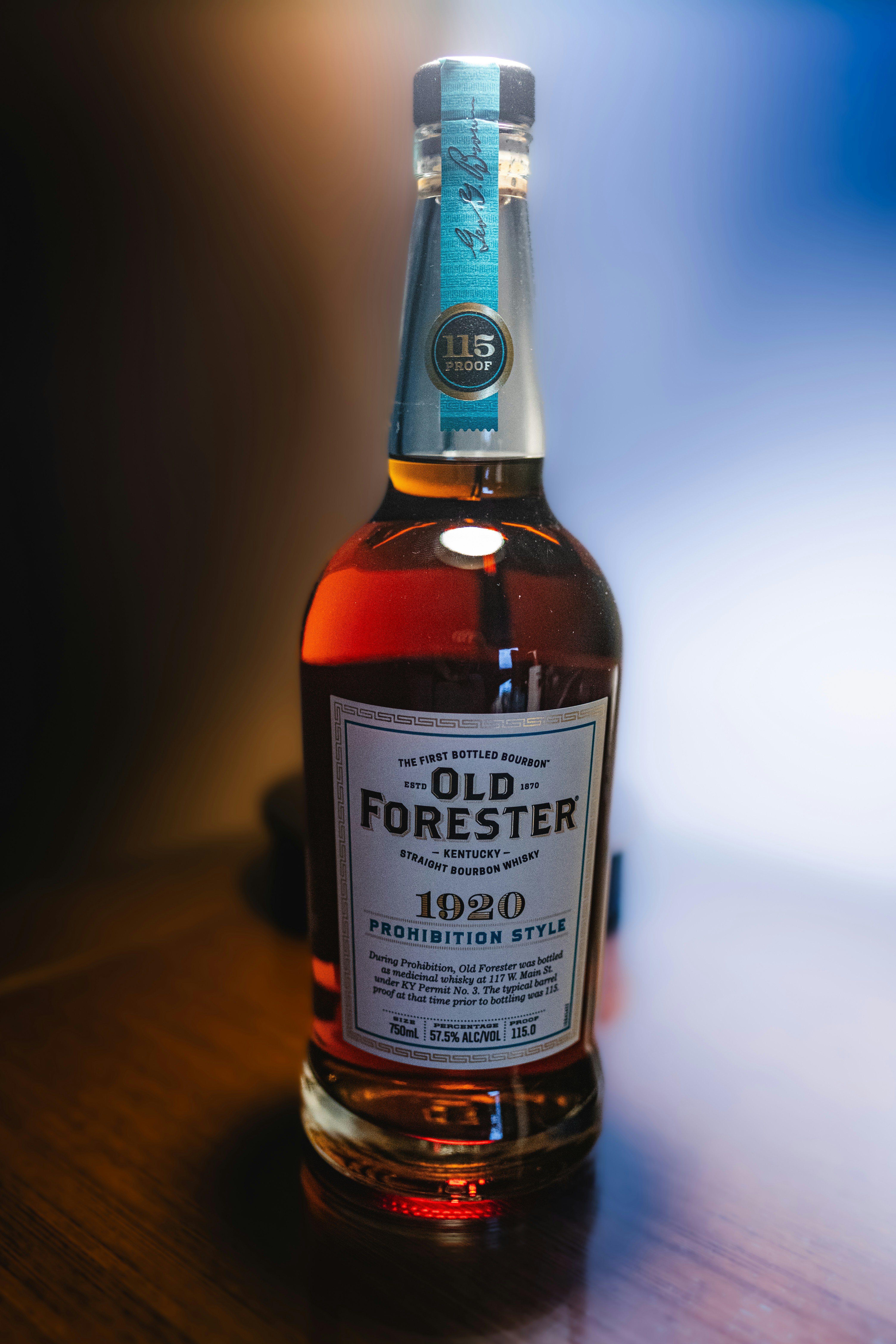 a bottle of old forester on a wooden table