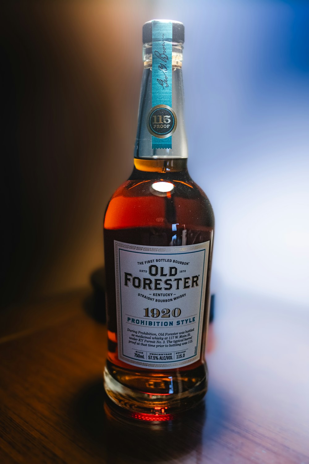 a bottle of old forester on a wooden table