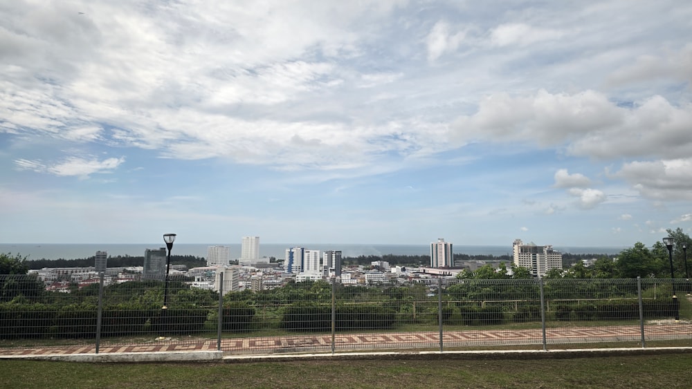 a view of a city from behind a fence