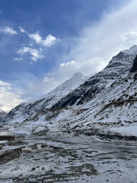 a snow covered mountain with a river running through it