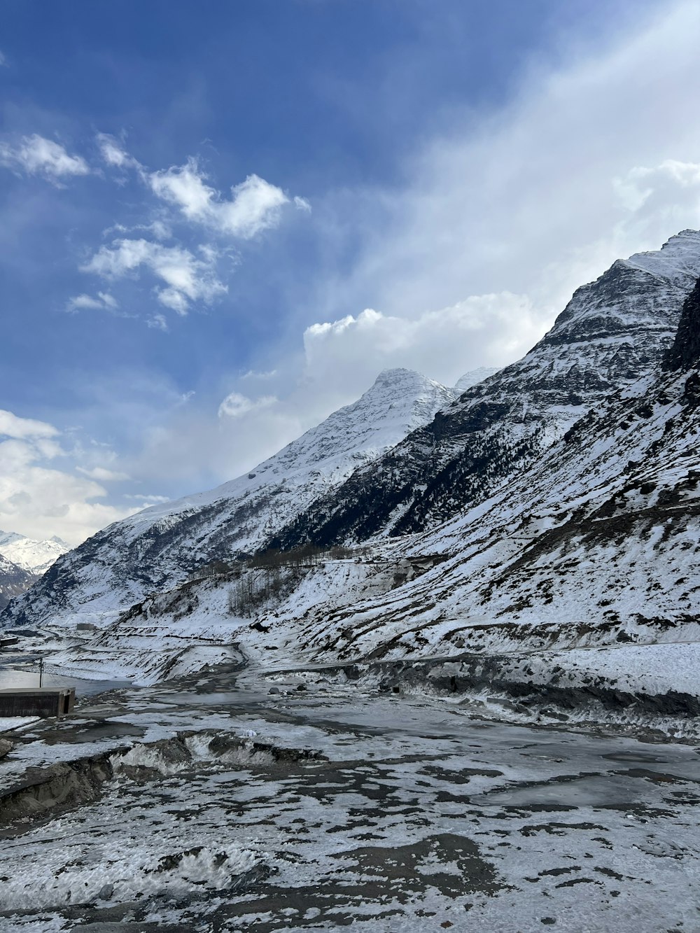 a snow covered mountain with a river running through it