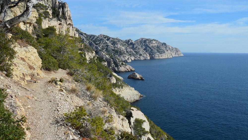 a rocky cliff overlooks a body of water