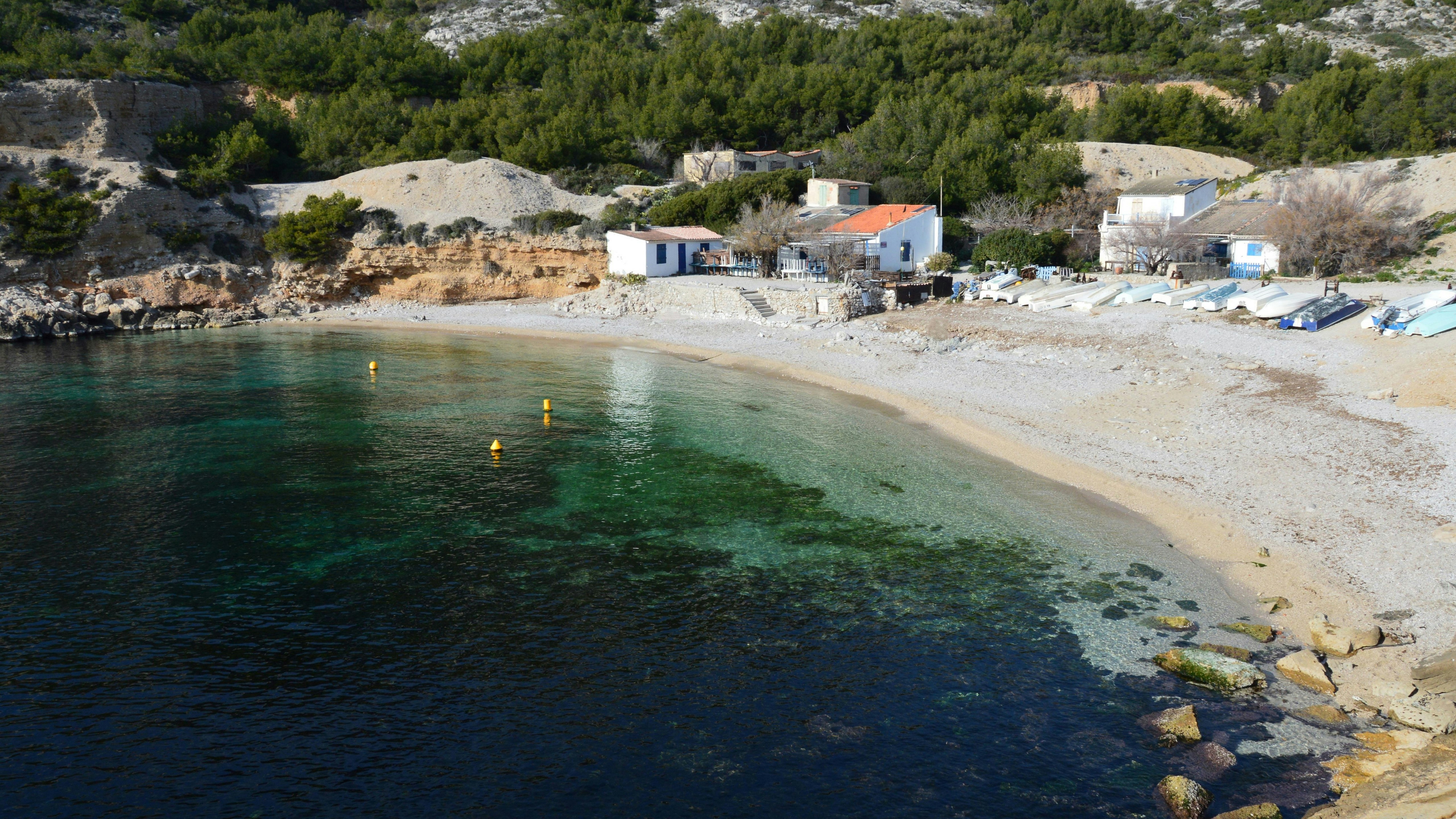 a body of water with a sandy beach next to it
