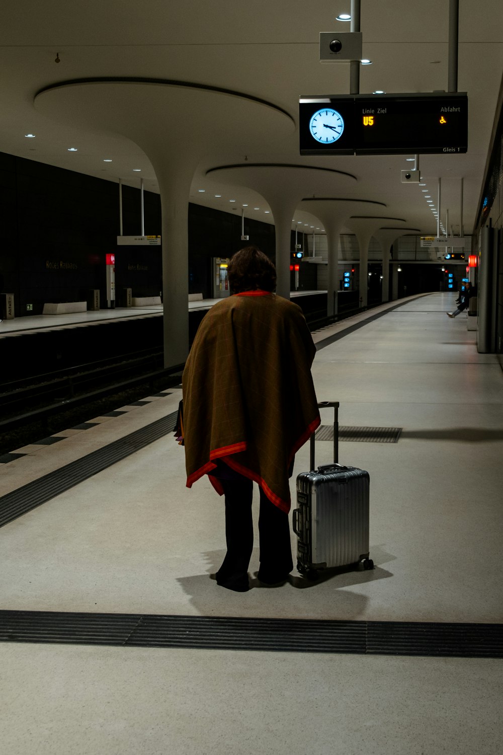 a person with a suitcase waiting for a train