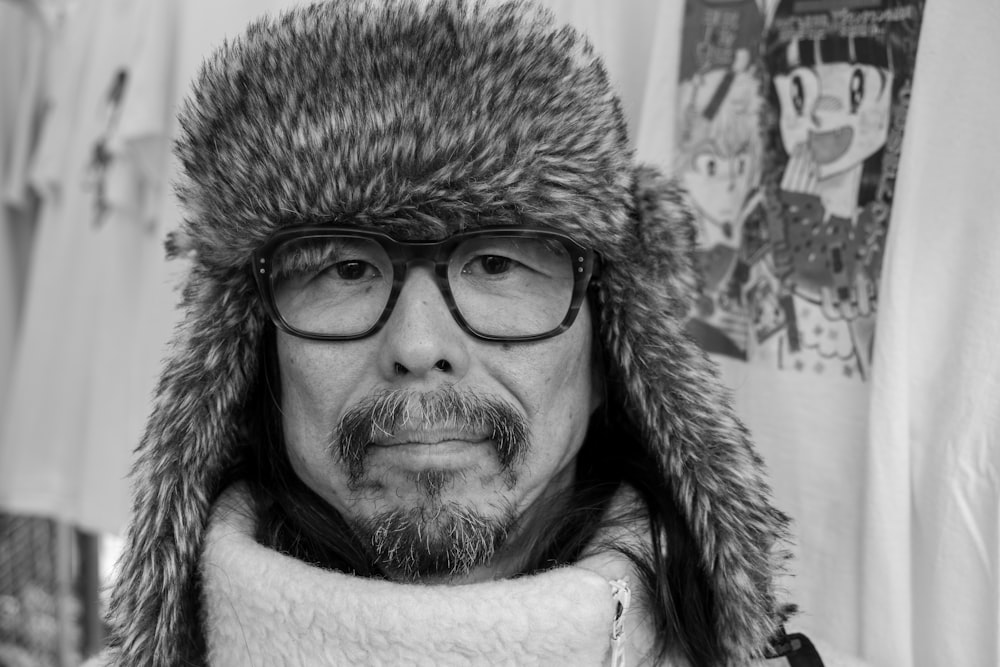 a man wearing a fur hat and glasses