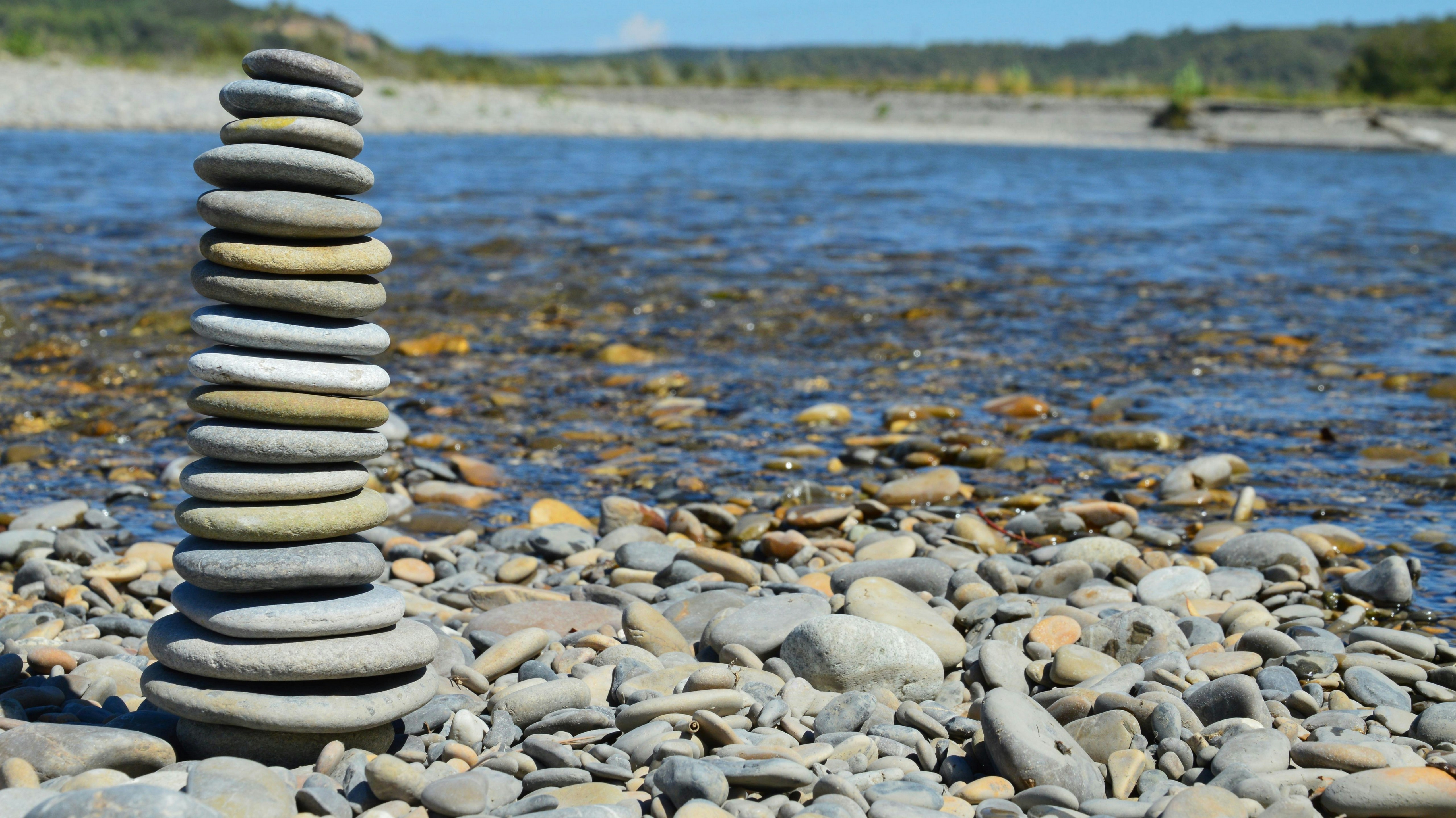 a stack of rocks sitting on top of a rocky beach