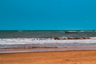 a boat is out in the ocean on a sunny day