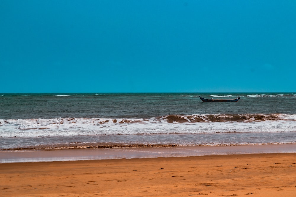 a boat is out in the ocean on a sunny day