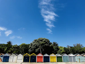 Porirua row of brightly colored beach huts under a blue sky