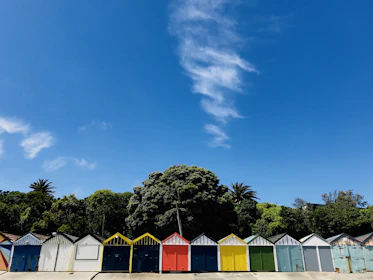 Porirua row of brightly colored beach huts under a blue sky