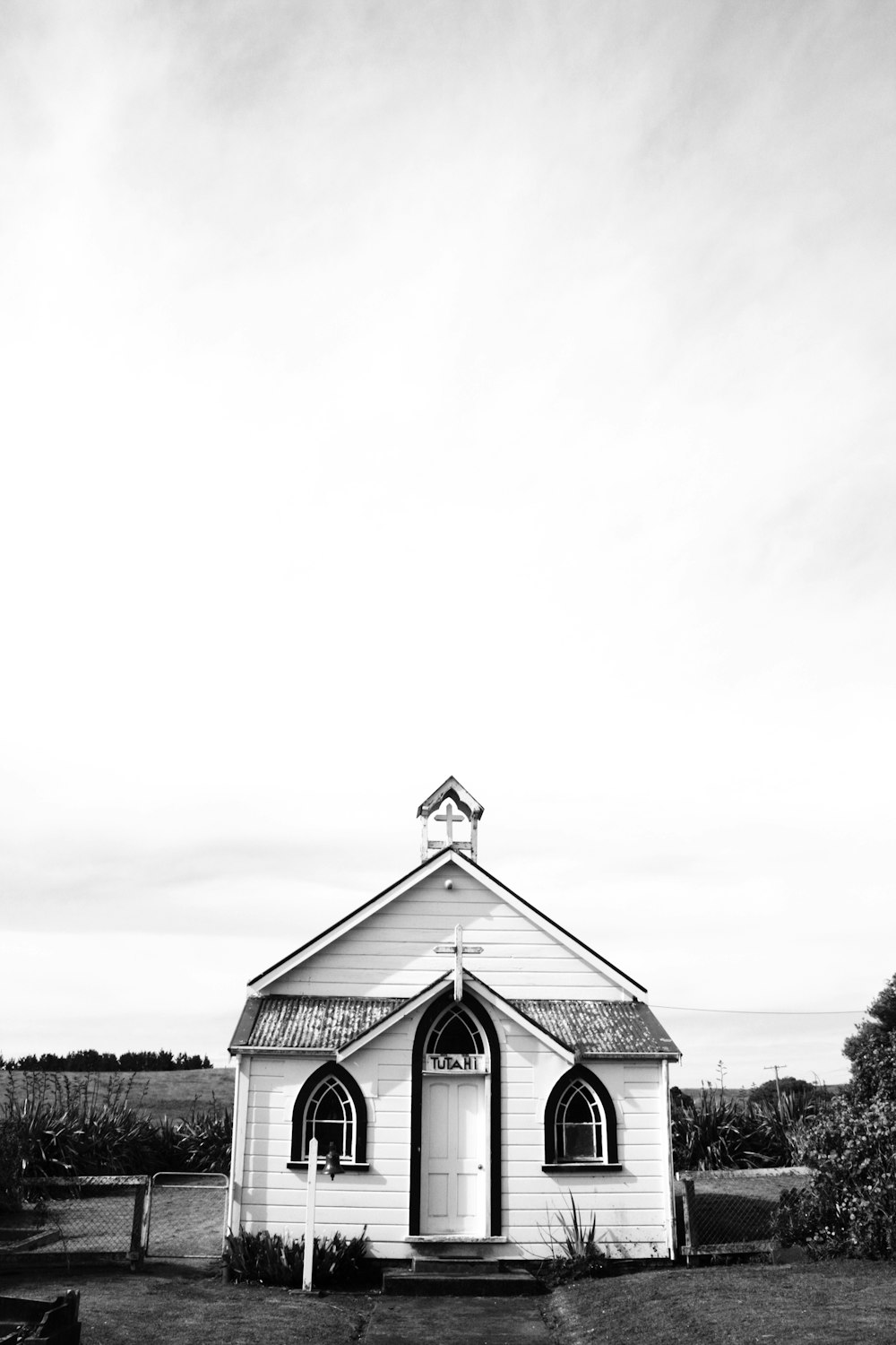 a black and white photo of a small church