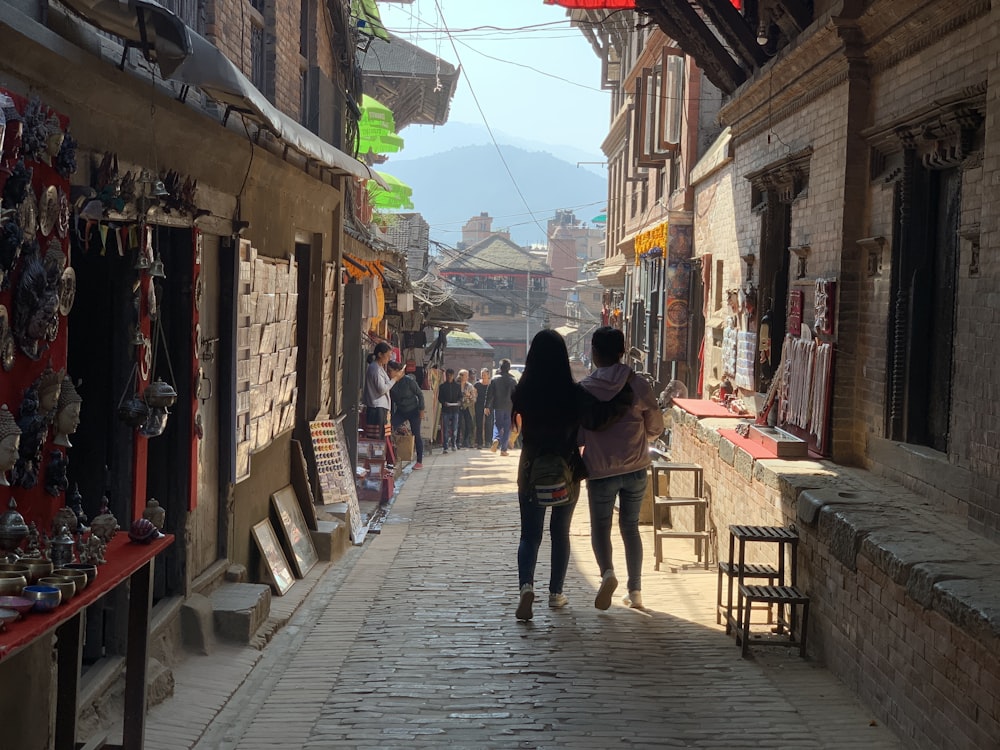 a couple of people walking down a street