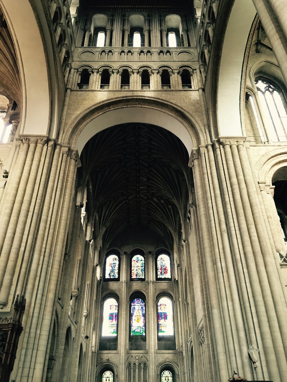 the interior of a large cathedral with stained glass windows