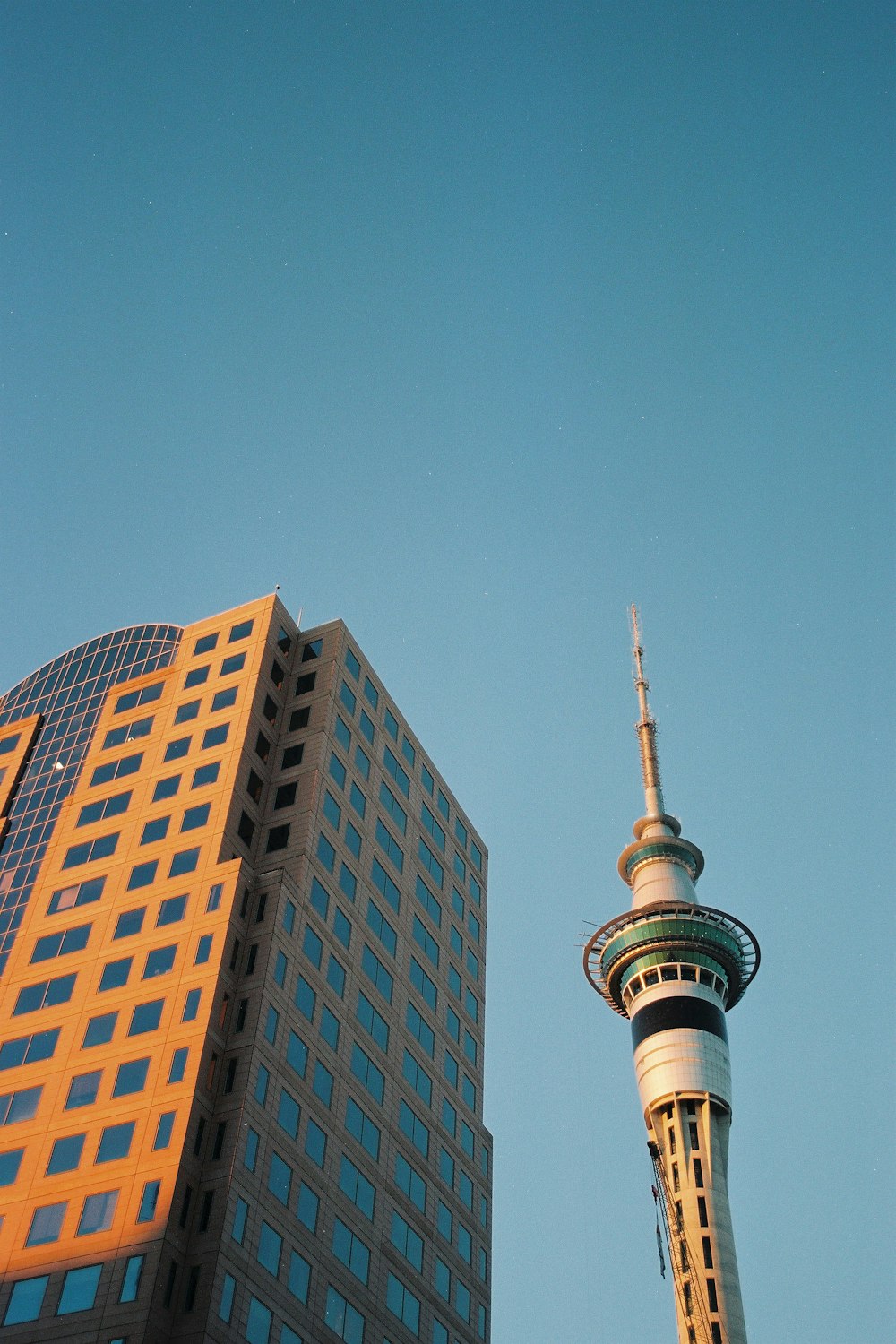 a tall building next to a very tall building