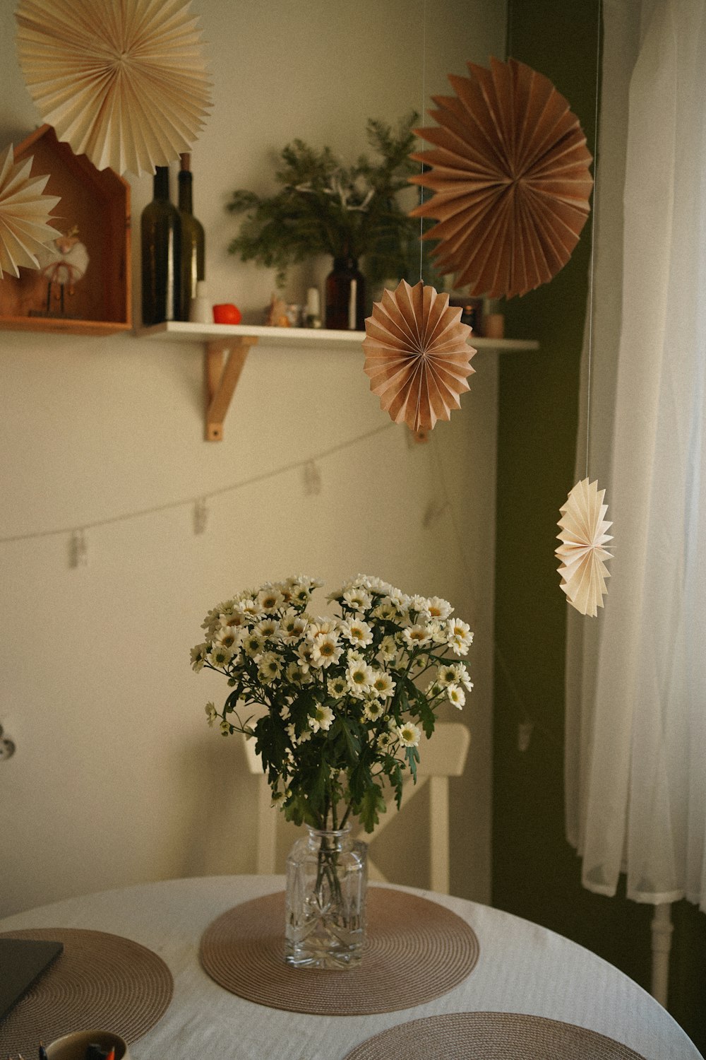 a vase filled with white flowers sitting on top of a table