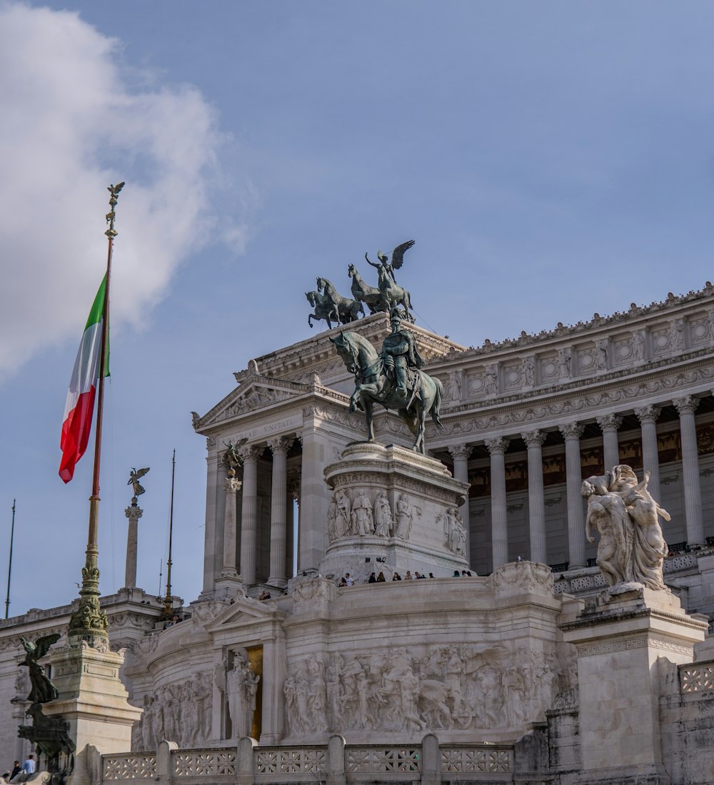 a statue of a man on a horse in front of a building