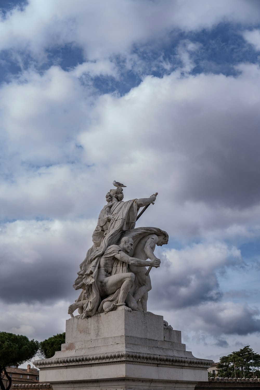 una estatua de un hombre montando a caballo frente a un cielo nublado