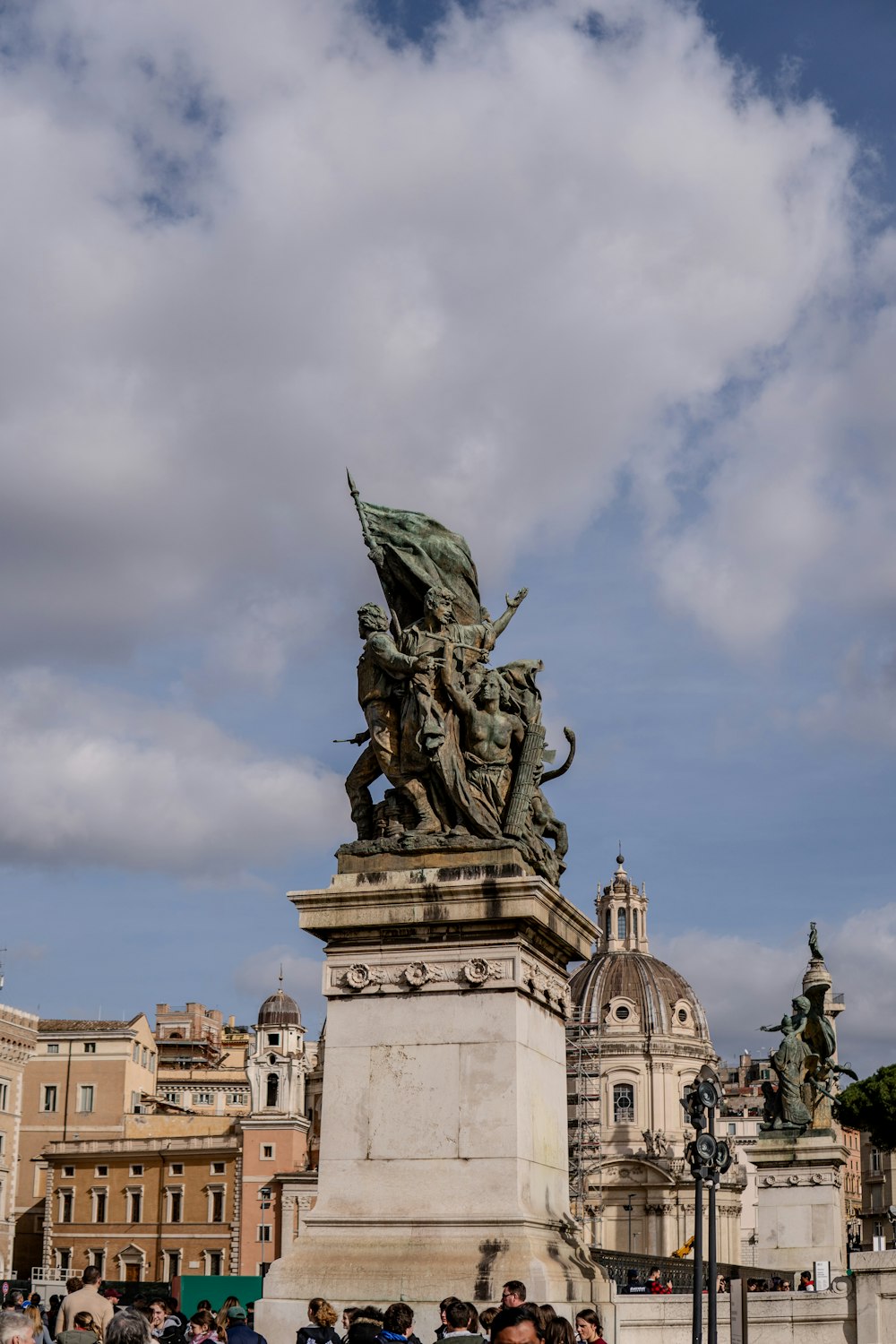 a group of people standing around a statue