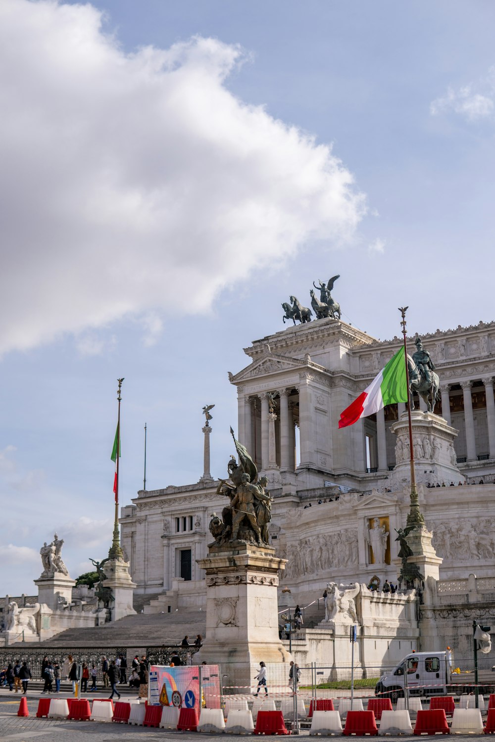 a large white building with a flag flying in front of it