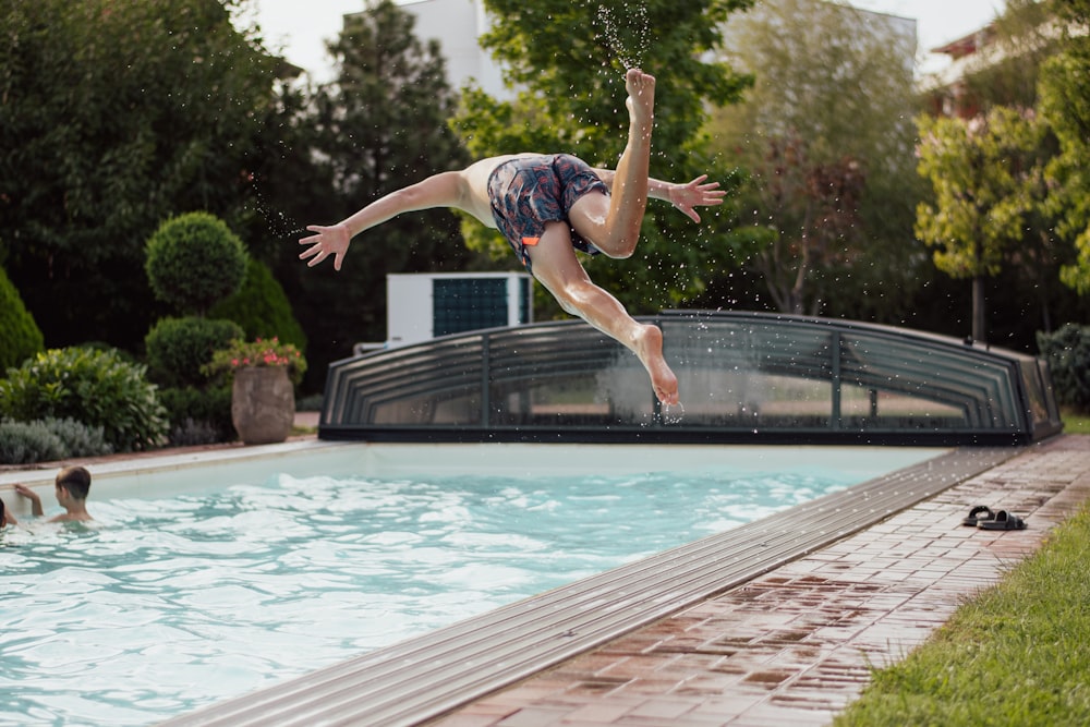 a person jumping into a pool of water