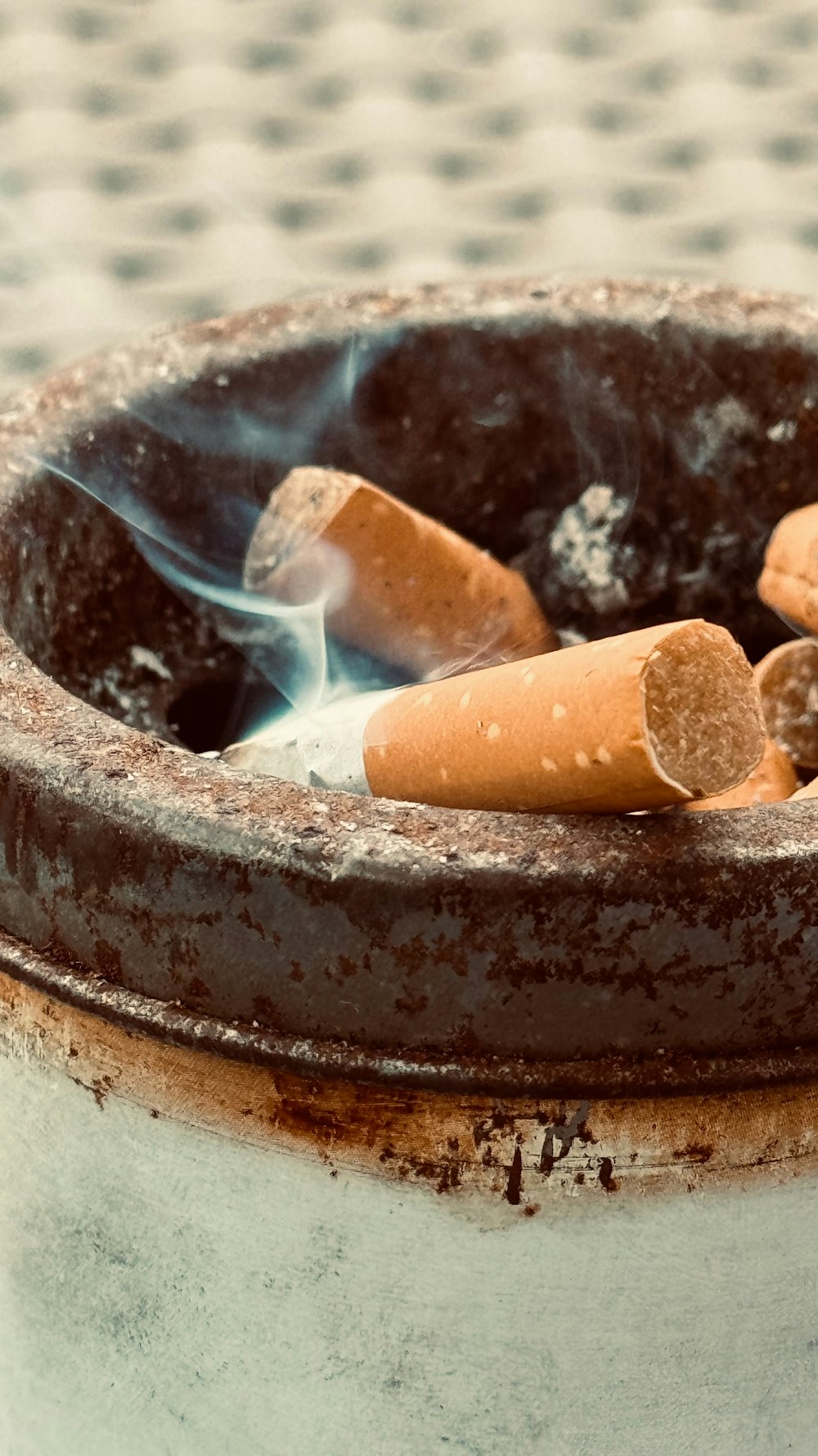 a close up of a bowl with a cigarette in it