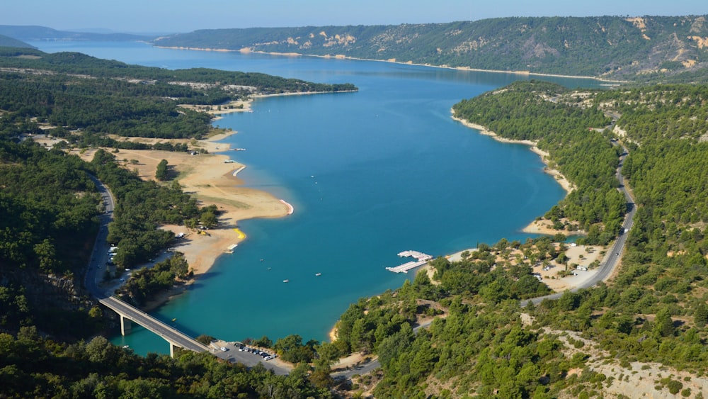 a large body of water surrounded by lush green trees